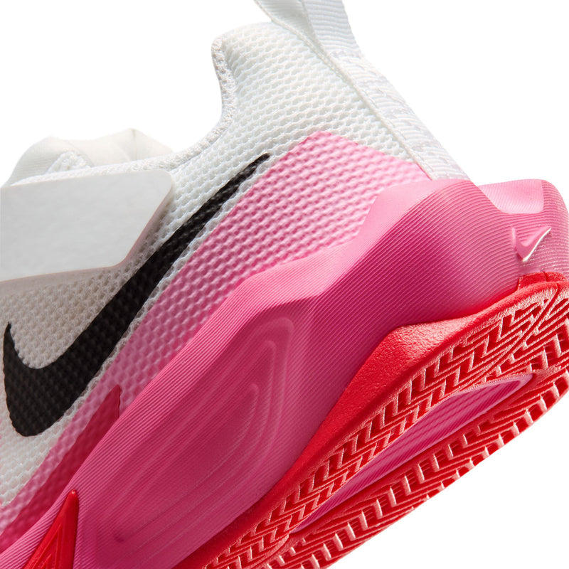 Kids' sneaker close-up: pink midsole and red outsole with patterned traction