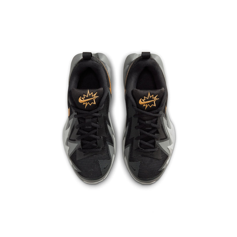 Youth basketball shoe pair, black uppers with gold logo on the tongue and lace area