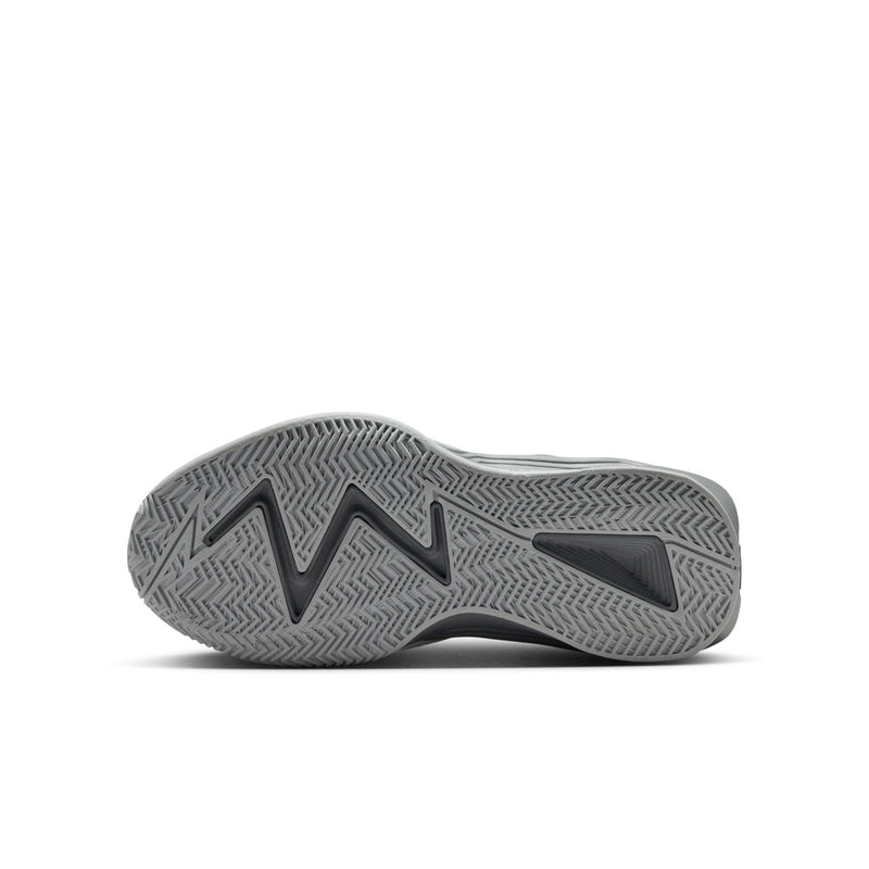 Youth basketball shoe outsole view, textured gray rubber tread
