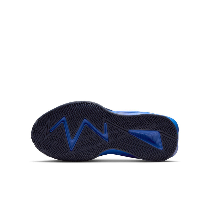 Youth sneaker outsole in dark navy with blue tread, molded chevron pattern.