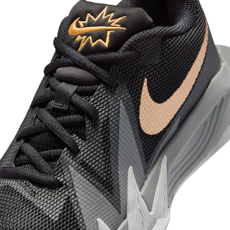 Youth basketball shoe close-up, black laces with gold logo on the tongue and swoosh