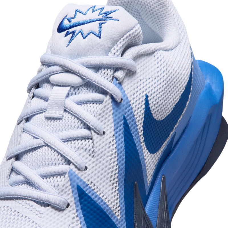 Close-up of youth sneaker upper: light gray mesh, blue Swoosh, white lace-up.