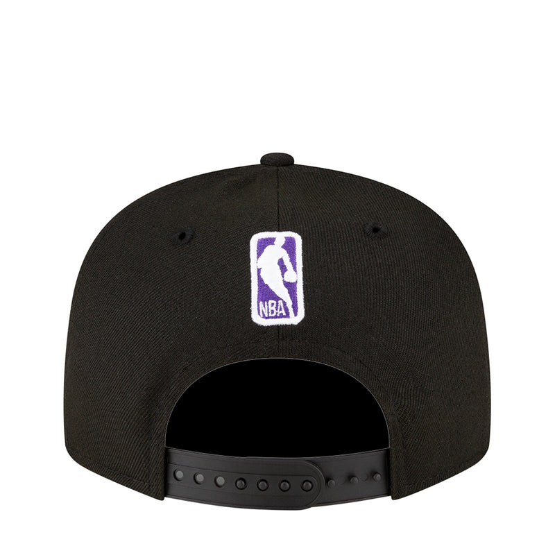 Black snapback baseball cap back view with small purple NBA logo patch