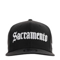 Black baseball cap with white Sacramento logo embroidery across front