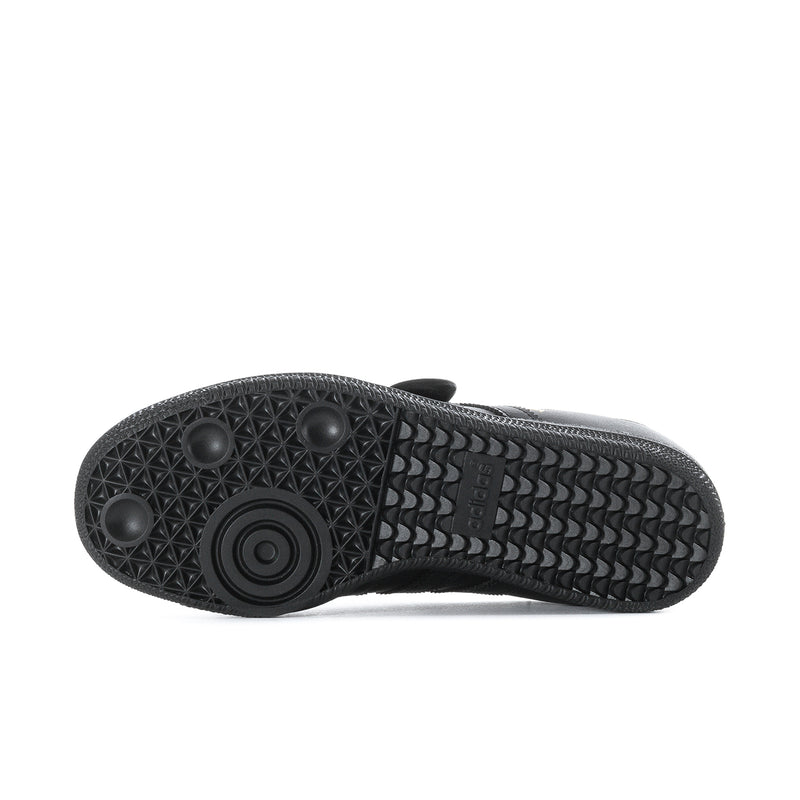 Black rubber outsole with textured tread pattern and circular grip detail