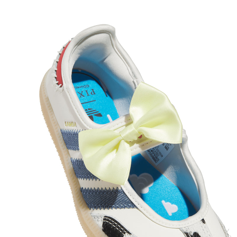 Kids sneakers inner side: white upper with blue lining, yellow bow on strap
