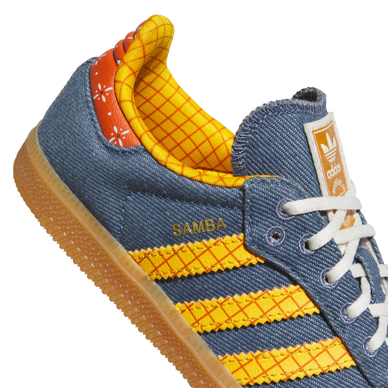 Kids sneaker upper close-up: blue fabric, yellow stripes, orange heel panel
