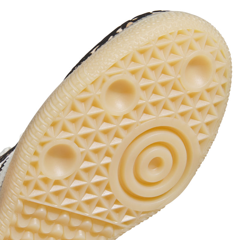 Kids Samba OG sneakers outsole close-up with circular traction pods on gum rubber