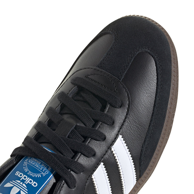 Close-up of black adidas Samba OG leather upper with black laces and white side stripe.
