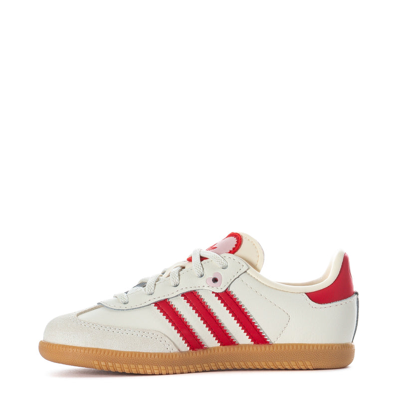 Toddler cream sneakers with red adidas-style stripes, lace-up front, gum sole