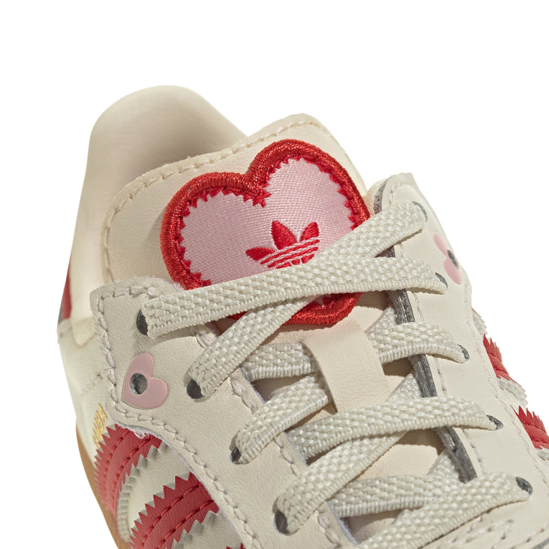 Toddler cream sneakers with red heart applique and lace-up front detail
