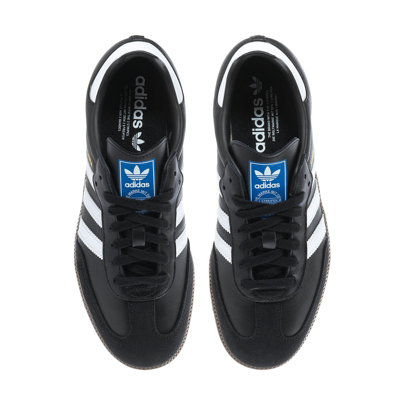 Black adidas sneakers, tongue logo with blue label; lace-up view