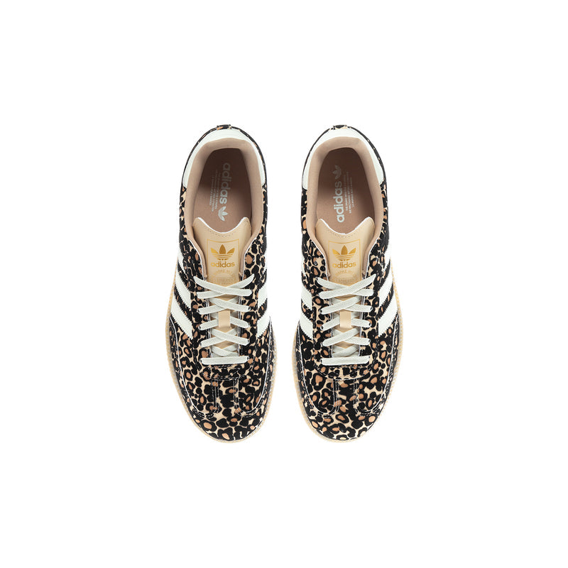 Youth low-top sneaker with leopard print, white laces, and tan interior lining