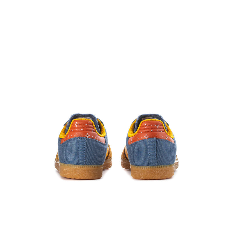 Kids' denim and yellow sneakers with orange heel accents and gum soles.