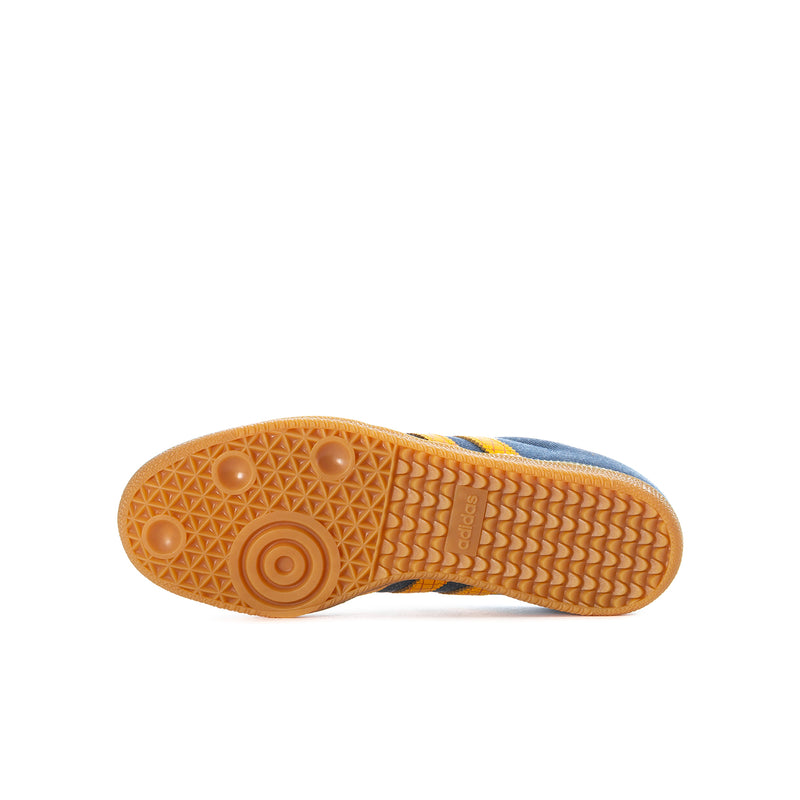Gum rubber outsole of kids' denim and yellow Samba sneakers.