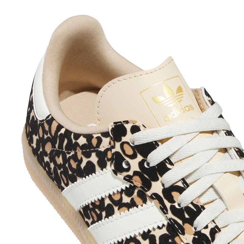 Youth sneaker close-up: beige collar, leopard print quarter, adidas logo on tongue