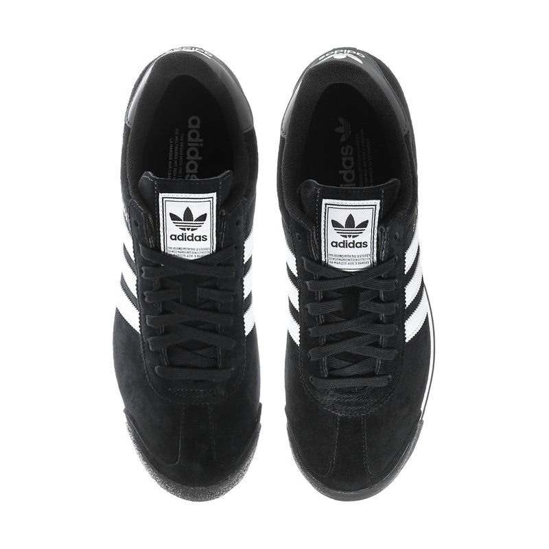 Black suede sneakers showing tongue adidas logo patches and white side stripes