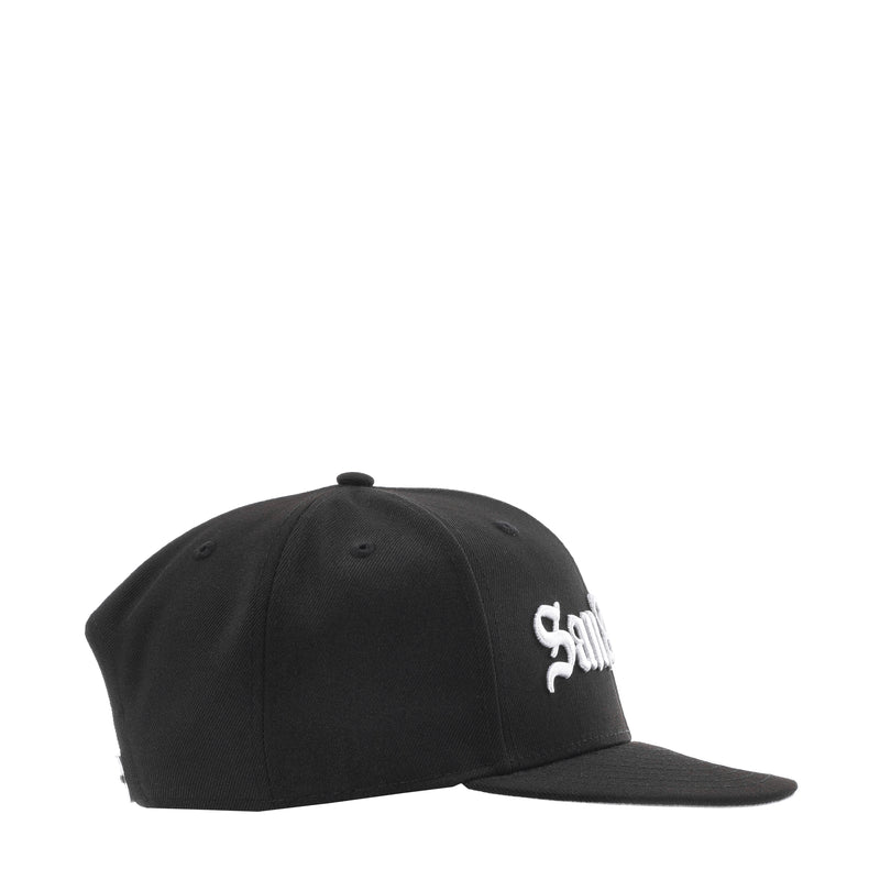 Black baseball cap with small white side script logo and curved brim, button top