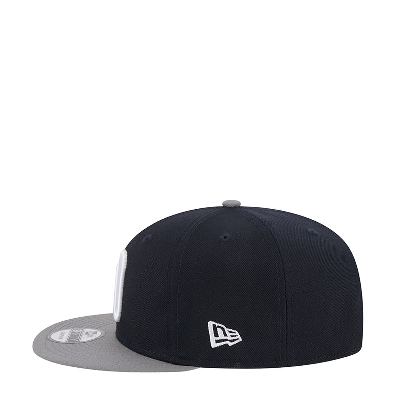 Two-tone snapback cap with small white New Era flag on dark crown