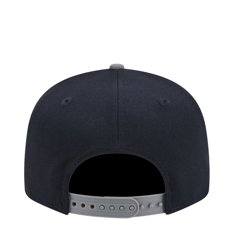 Two-tone snapback cap back view with adjustable eyelet strap on dark crown