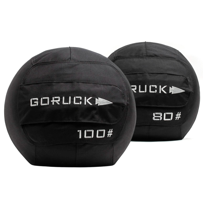 Two black Medicine Ball Bundle sandbags labeled 100 and 80 sit side by side on a white background, ideal for home gyms or portable training sessions.