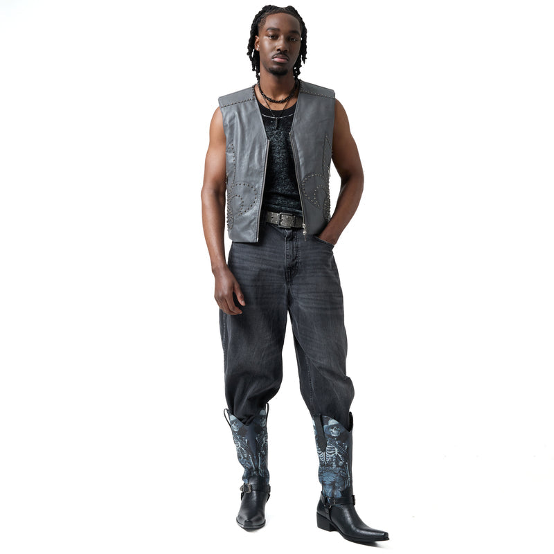 Person wearing a gray vest, black pants, and black boots on a white background