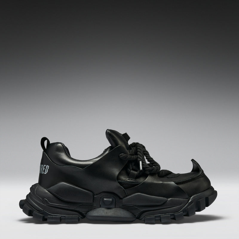 Black sneakers on a gradient gray background
