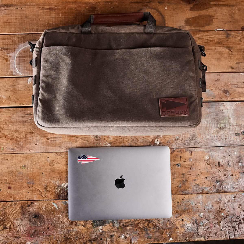 GORUCK brown rucking laptop bag and MacBook on rustic wooden table