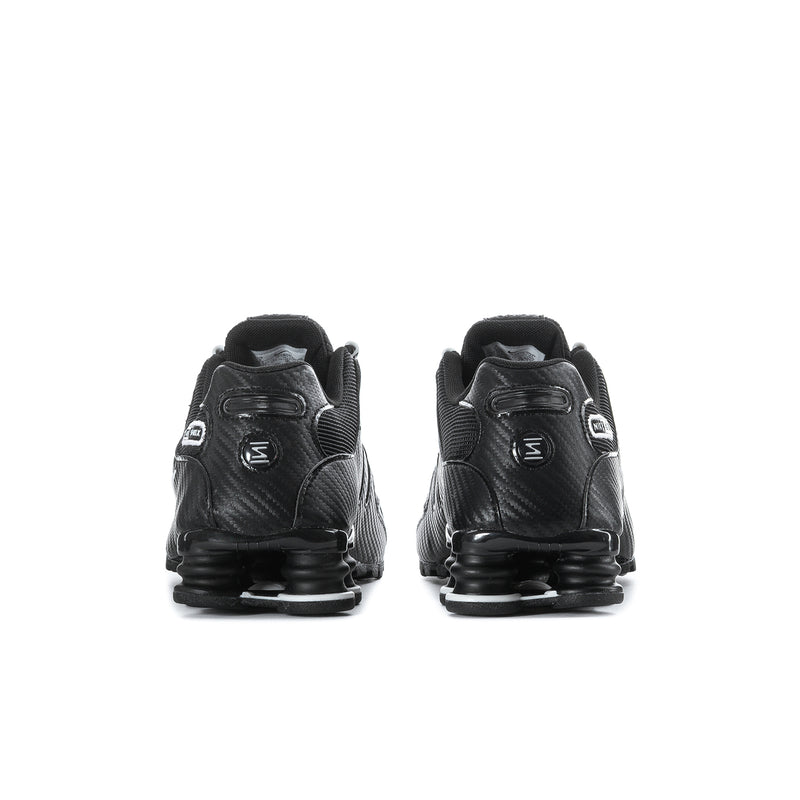 Men's black Nike sneakers, rear view with heel cushioning and Shox-style pods