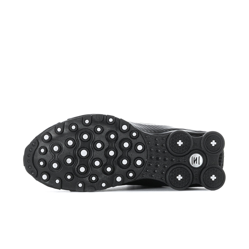 Men's black sneaker outsole with rubber traction pods and circular tread pattern