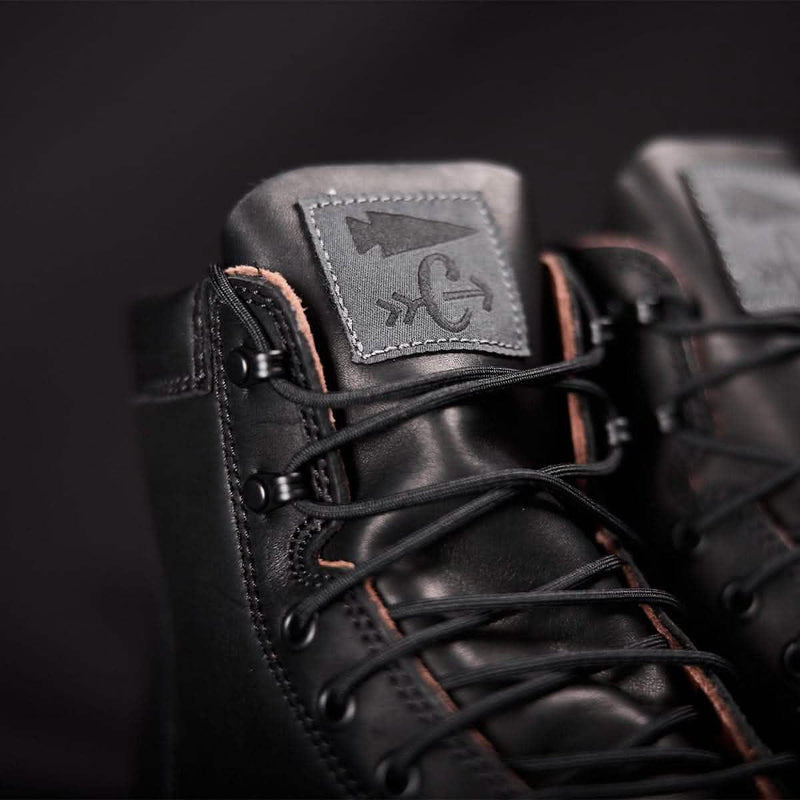 Close-up of black GORUCK rucking boots with logo patch and detailed laces