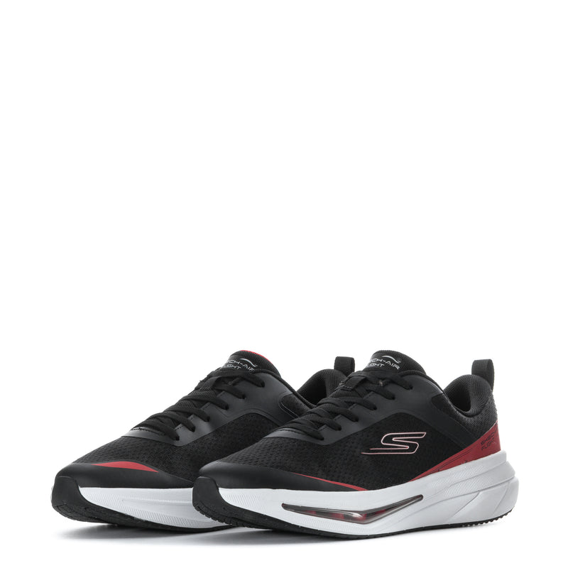 Pair of youth black sneakers with red side details, white sole, and lace-up uppers