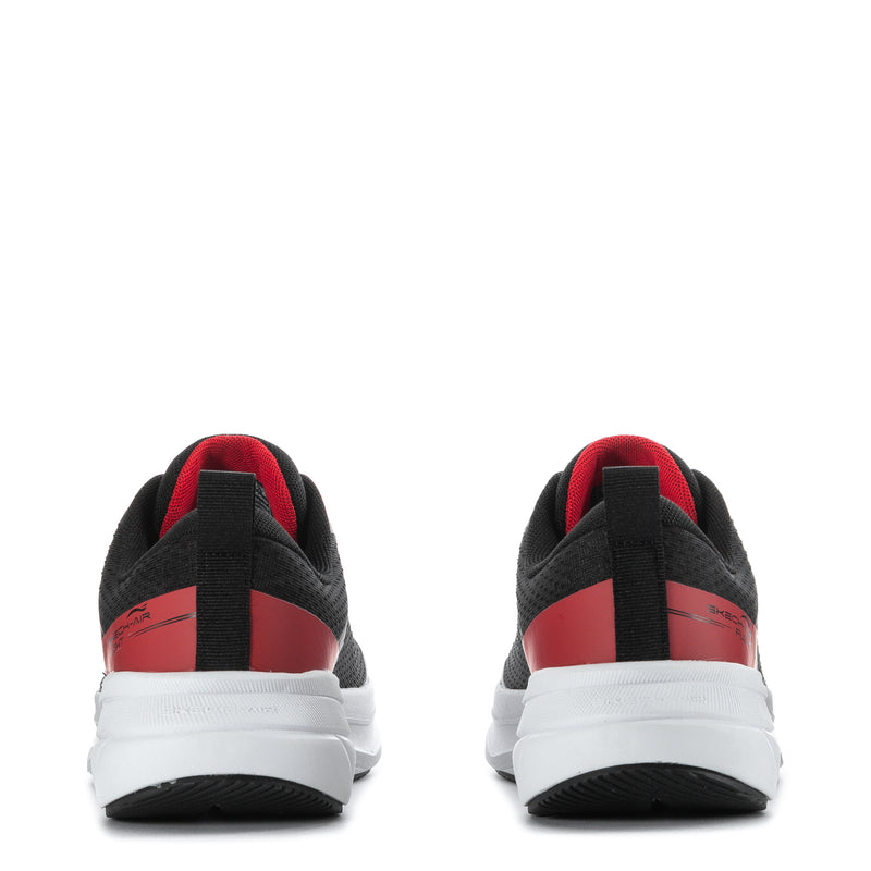 Youth black sneakers rear view with red heel panel and white cushioned sole