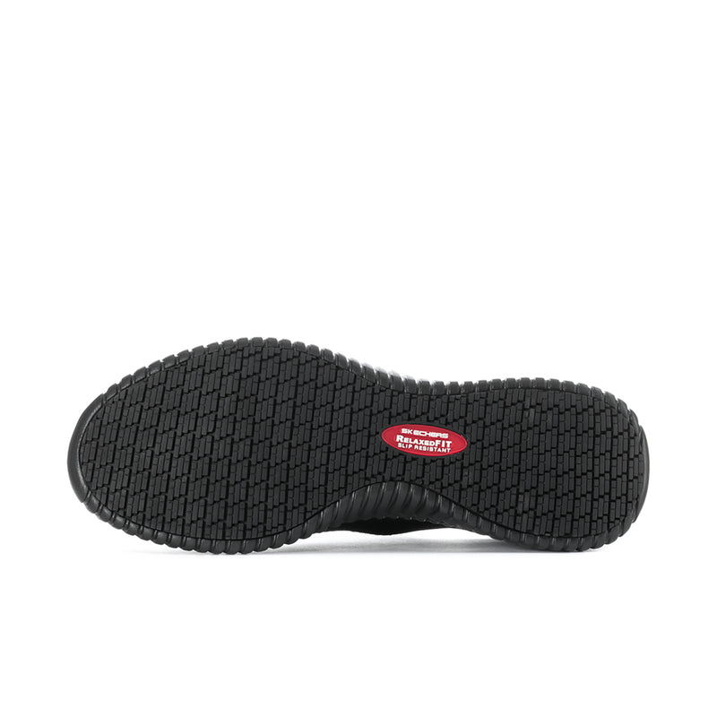 Black outsole of slip-on sneakers with grippy tread pattern and red logo