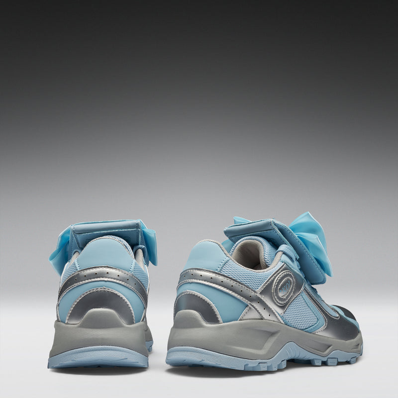Pair of blue and gray sneakers on a gradient background