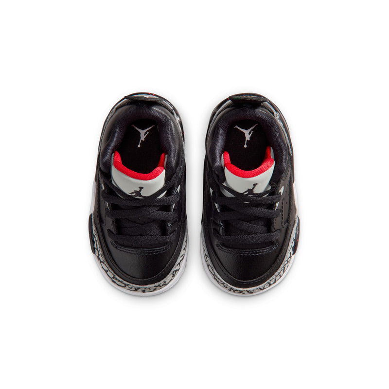 Toddler black sneakers with red accents and white Jordan logo on tongue.
