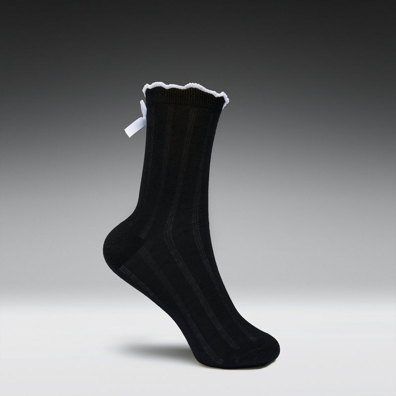 Black sock with white trim on a gray background