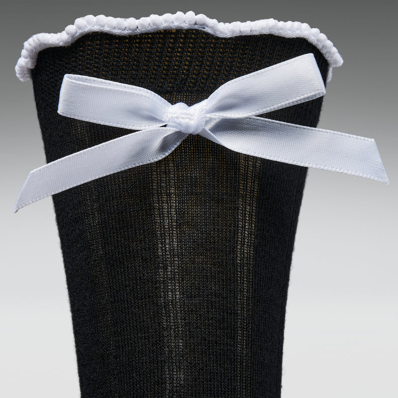 Black sock with a white bow on a gray background