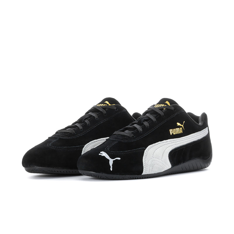 Pair of men's black low-top sneakers with white Puma stripe and lace-up design