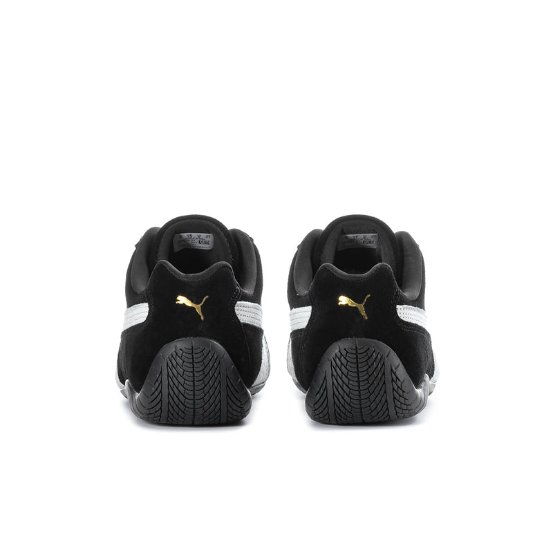 Men's black low-top sneakers, heel view with white stripe and Puma logo