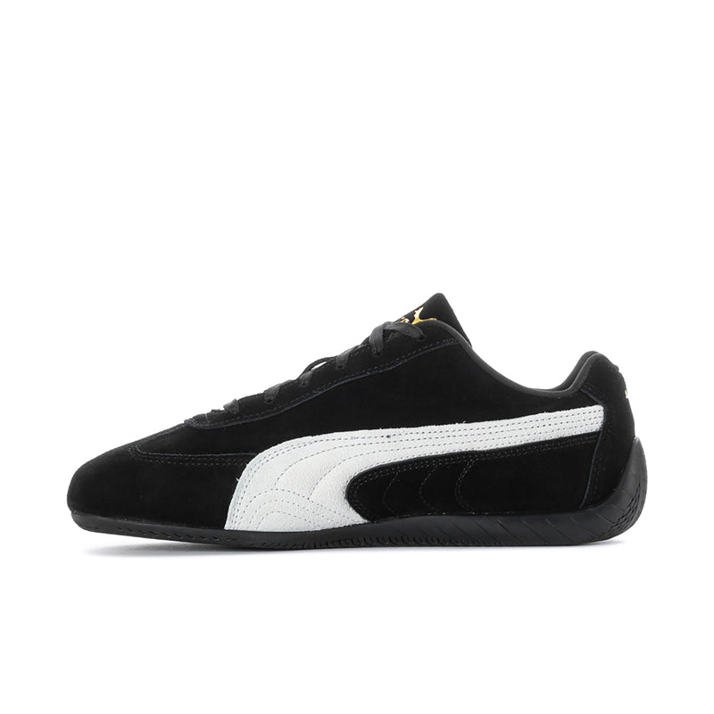 Men's black low-top sneakers with white Puma stripe and gold accent on tongue