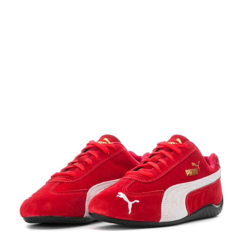 Pair of red and white low-top women's sneakers with Puma logo on vamps