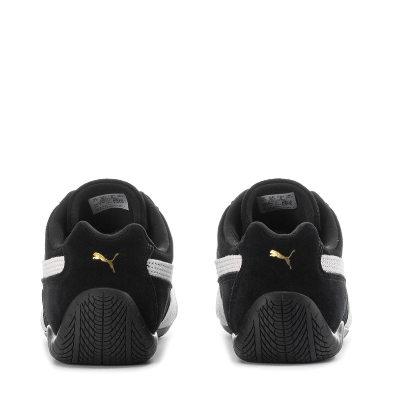 Puma women's low-top sneakers heel view, black suede with white heel stripe and Puma logo
