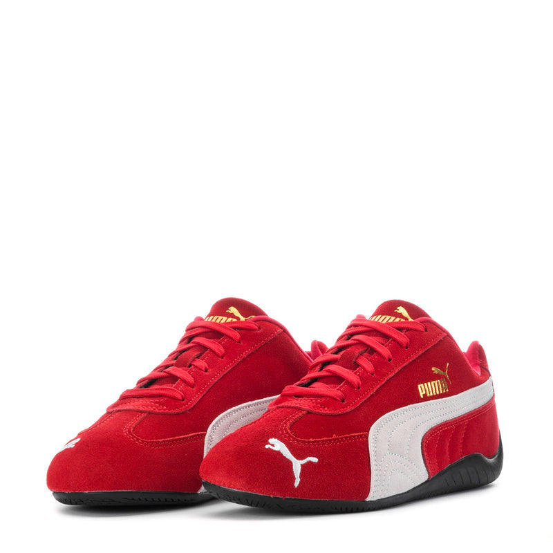 Youth red sneakers with white stripes, red laces, and PUMA cat logo on the sides