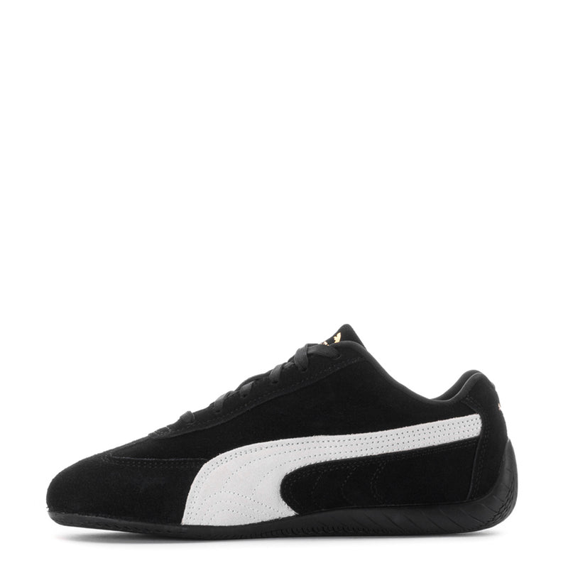 Youth black Puma sneaker with white stripe panel and Puma cat logo on side