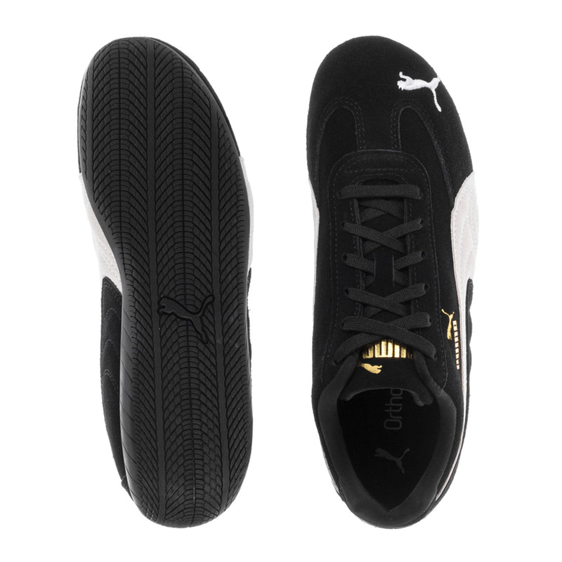 Youth Puma sneaker outsole and side view, black upper with white heel panel