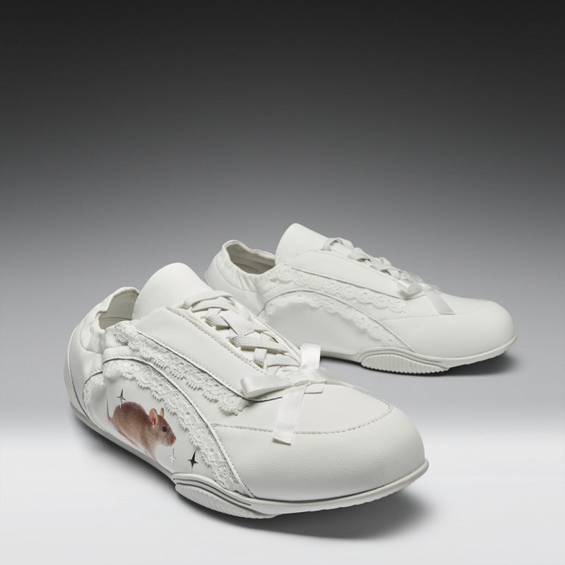 White sneakers with a small design on a gray background