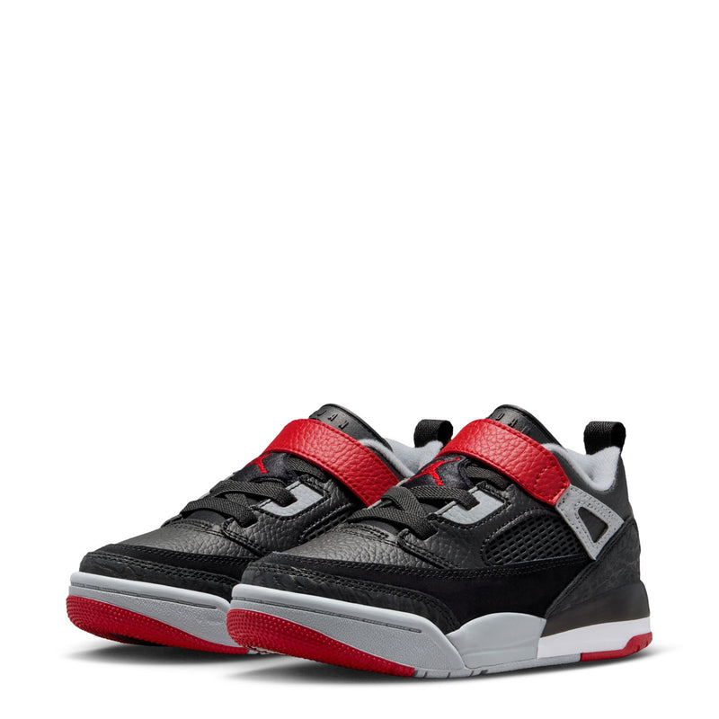 Pair of kids low-top sneakers with black uppers, red straps, and light gray soles