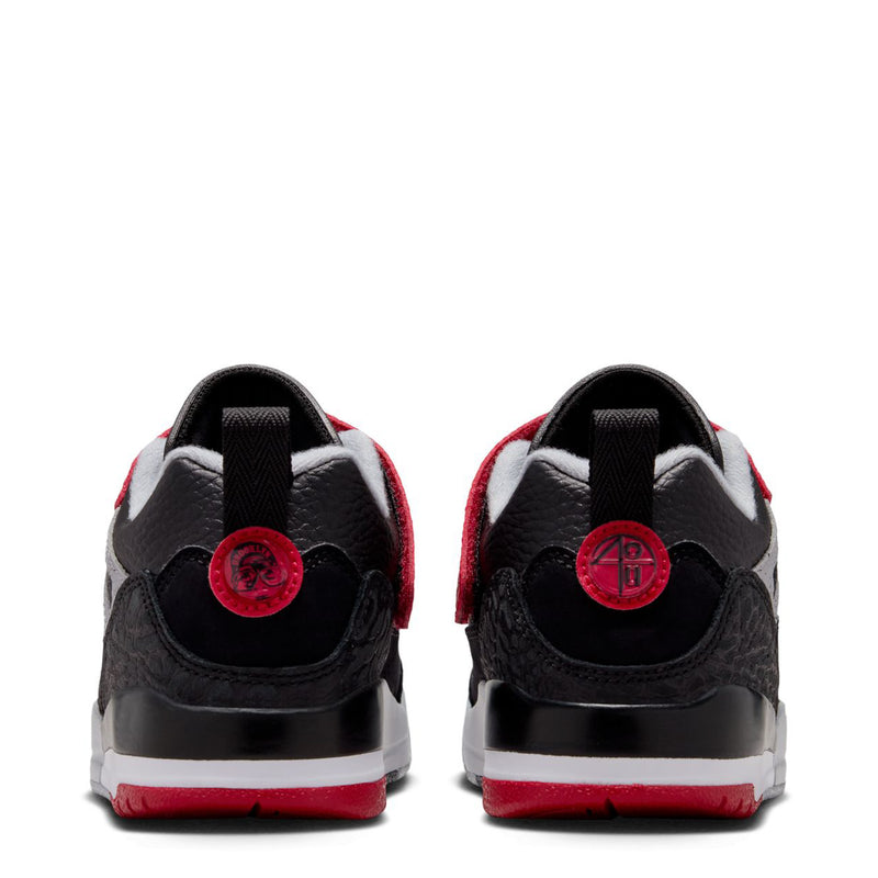 Kids low-top sneakers back view with black heel tabs and red circular branding patch
