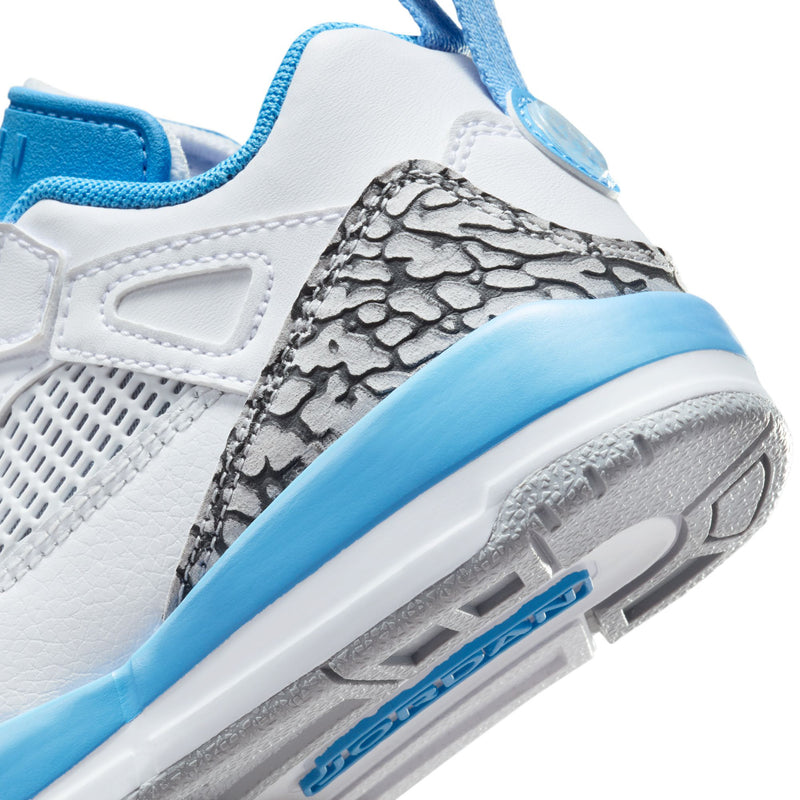 Kids sneaker close-up: white upper with grey snake-texture panel and blue outsole